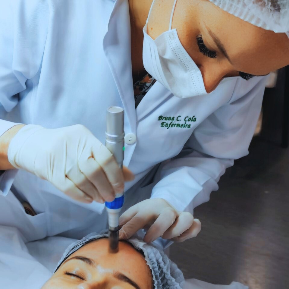 Uma profissional de saúde realizando um procedimento estético no rosto de uma paciente.